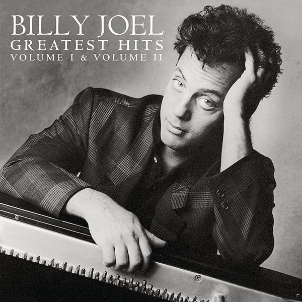 Album cover of Billy Joel's Greatest Hits, Volume 1 & 2, featuring a black-and-white photo of Billy Joel resting his head on his hand, leaning on a piano, wearing a blazer.