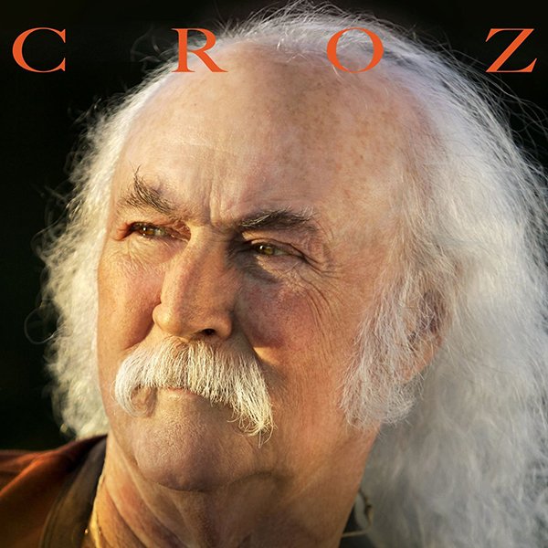 Close-up portrait of an elderly man with long white hair and a mustache, looking thoughtfully to the side, with the word 'CROZ' partially visible at the top.