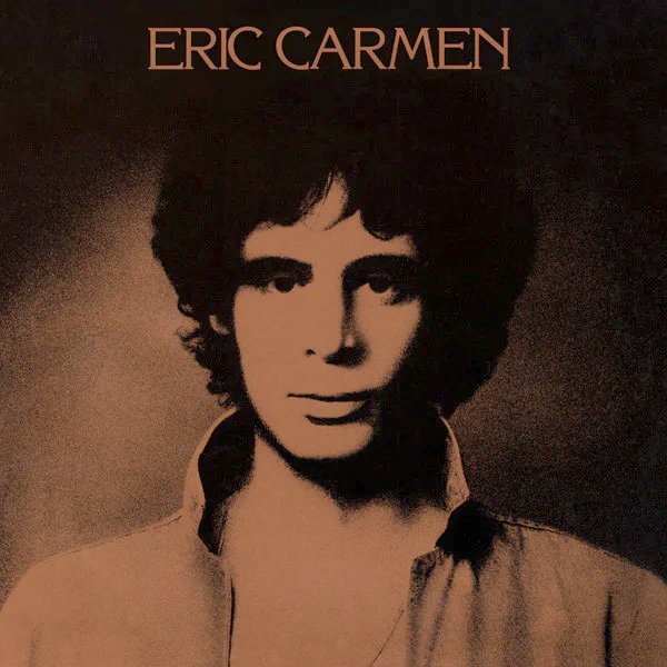Black and white portrait of Eric Carmen with the text 'ERIC CARMEN' at the top.