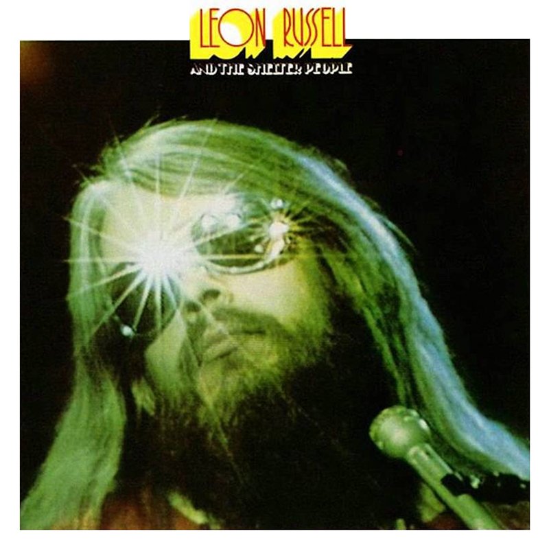 Album cover of Leon Russell's 'And the Shelter People', featuring a green-tinted, stylized portrait of a man with long hair and a beard wearing sunglasses, with a microphone in the foreground and a bright star-like reflection on his glasses.