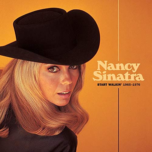 Nancy Sinatra wearing a large black hat, with text indicating her name and the album title 'Start Walkin'' from 1965-1976 against an orange background.