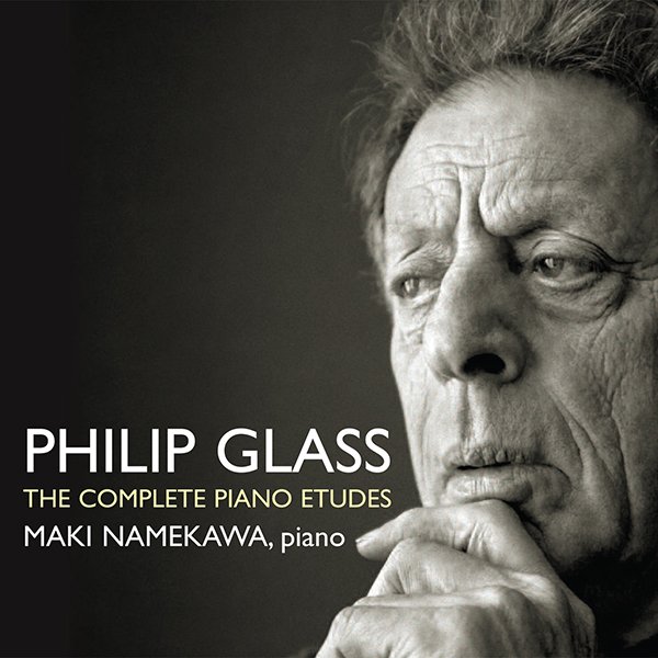 Black and white portrait of Philip Glass with his hand near his face, looking thoughtful, with text about his piano études by Maki Namekawa.