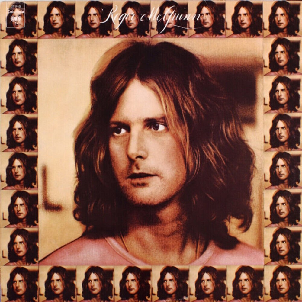 Album cover featuring a central portrait of a man with shoulder-length brown hair, surrounded by smaller images of the same person in a grid pattern. The text