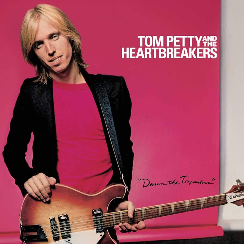 Cover of Tom Petty and the Heartbreakers album with Tom Petty holding a guitar against a pink background.